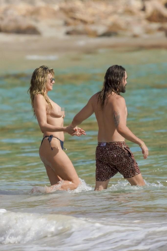 Kaulitz accompanied his wife in the water wearing a pair of animal print swim trunks.  